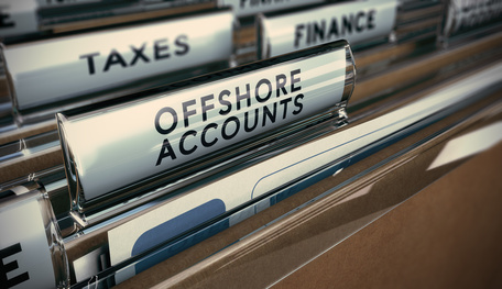 Folder tabs with focus on offshore account tab. Business concept image for illustration of tax evasion.